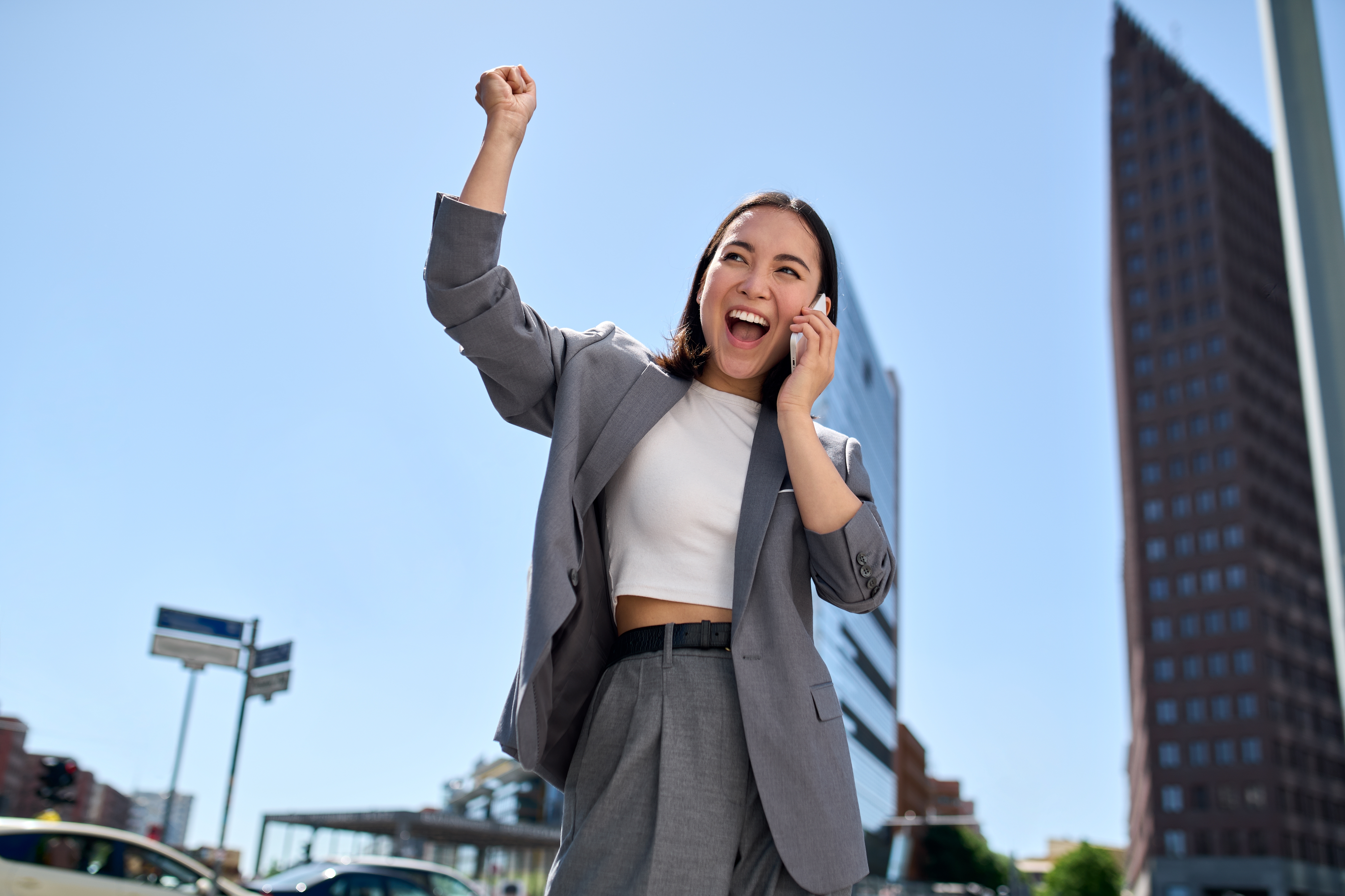 Young,happy,excited,asian,business,woman,entrepreneur,winner,standing,on